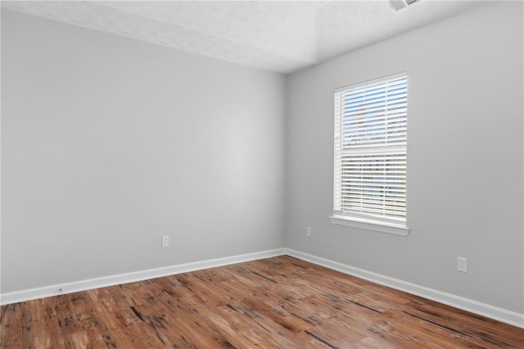 21 Timber Ridge Drive Cartersville, GA 30121 - Photo 13 of 24 a view of an empty room with wooden floor and a window