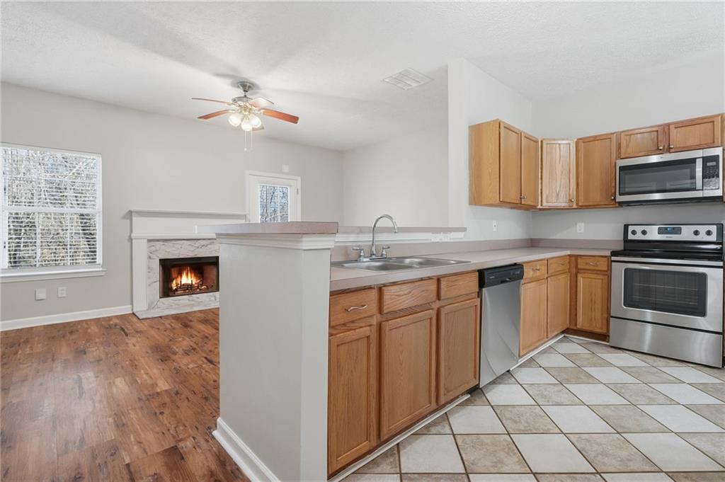 21 Timber Ridge Drive Cartersville, GA 30121 - Photo 2 of 24 a kitchen with granite countertop a stove top oven microwave and cabinets