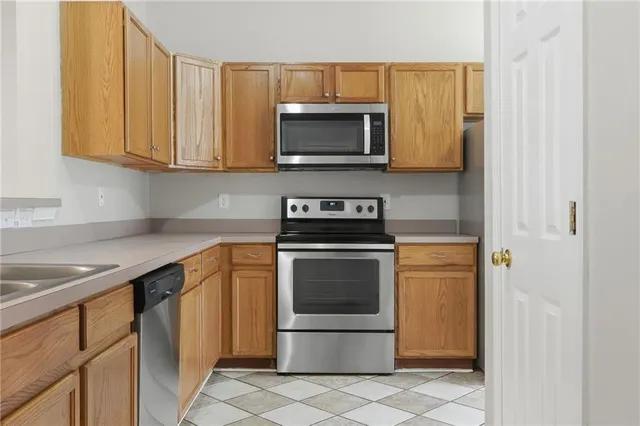 a kitchen with stainless steel appliances granite countertop a sink and a microwave