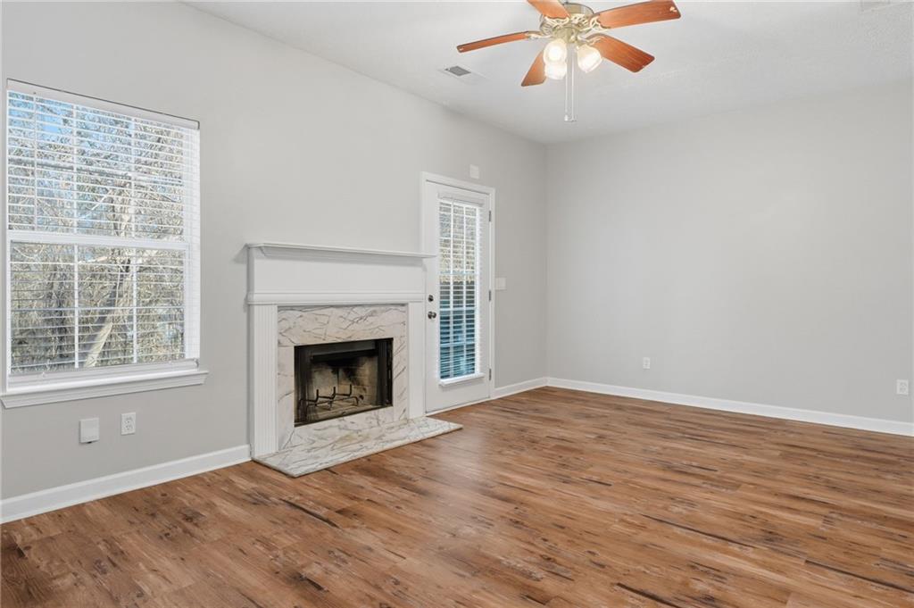 21 Timber Ridge Drive Cartersville, GA 30121 - Photo 7 of 24 a view of an empty room with wooden floor fireplace and a window