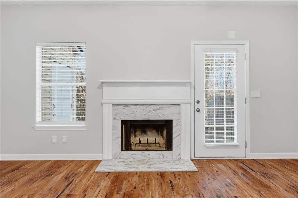 21 Timber Ridge Drive Cartersville, GA 30121 - Photo 8 of 24 a view of an empty room with wooden floor fireplace and a window