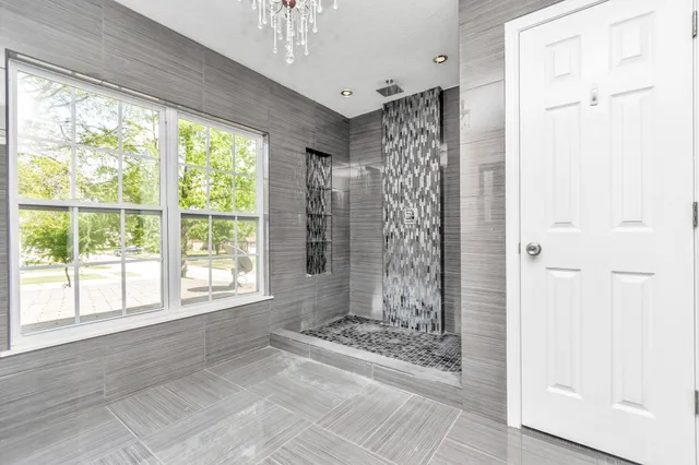 a view of a bathroom with a shower curtain and a large window