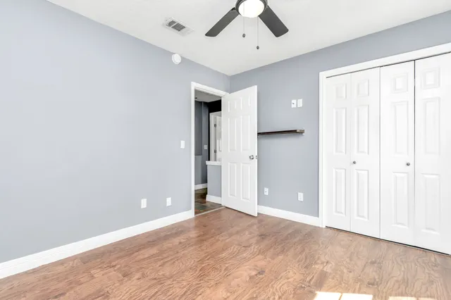 wooden floor in an empty room with a window