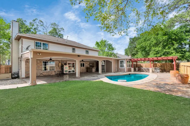 a view of a house with a yard and sitting area