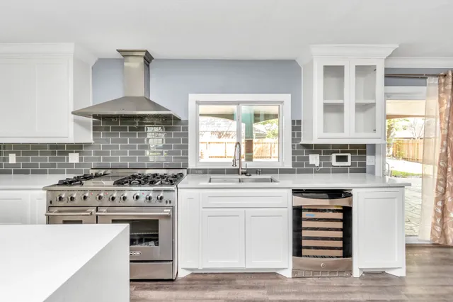 a kitchen with a stove top oven sink and cabinets
