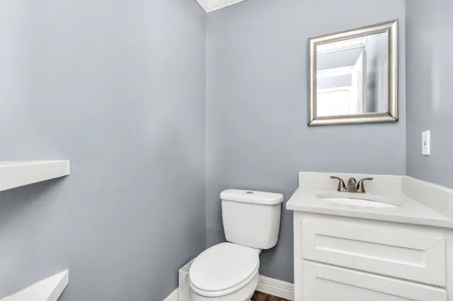 a white toilet sitting next to a bathroom sink