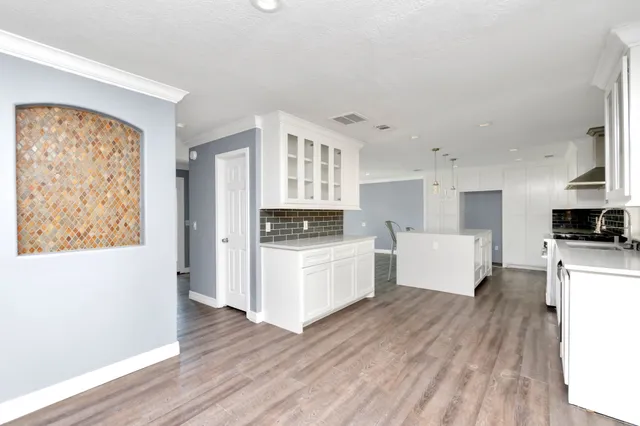 a kitchen with white cabinets and white appliances