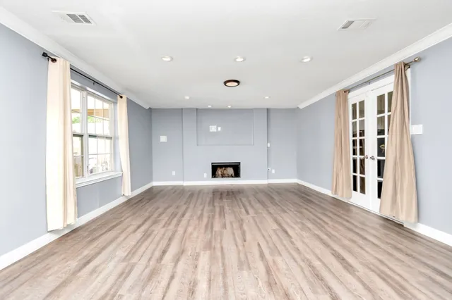 wooden floor in an empty room with a window