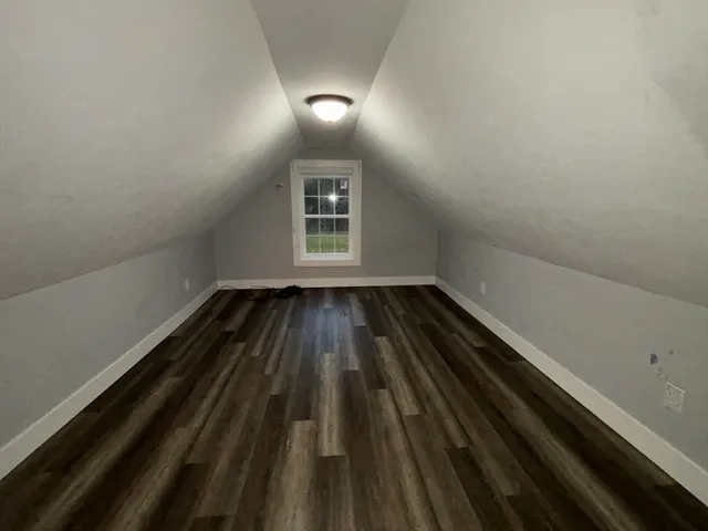 a view of a room with wooden floor