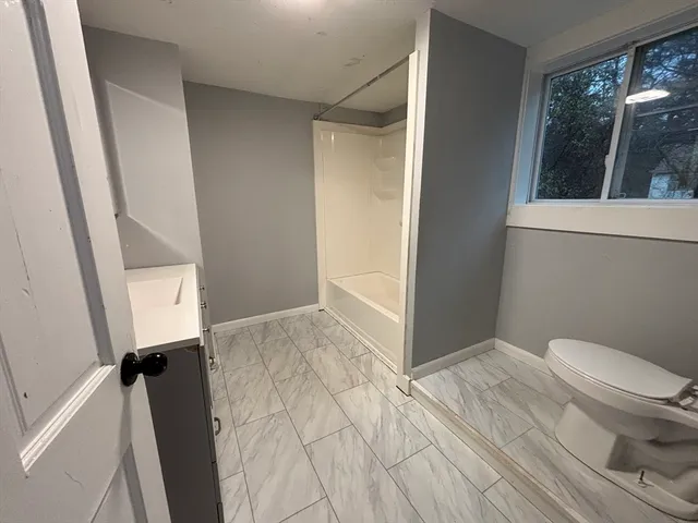 a bathroom with a toilet and a shower