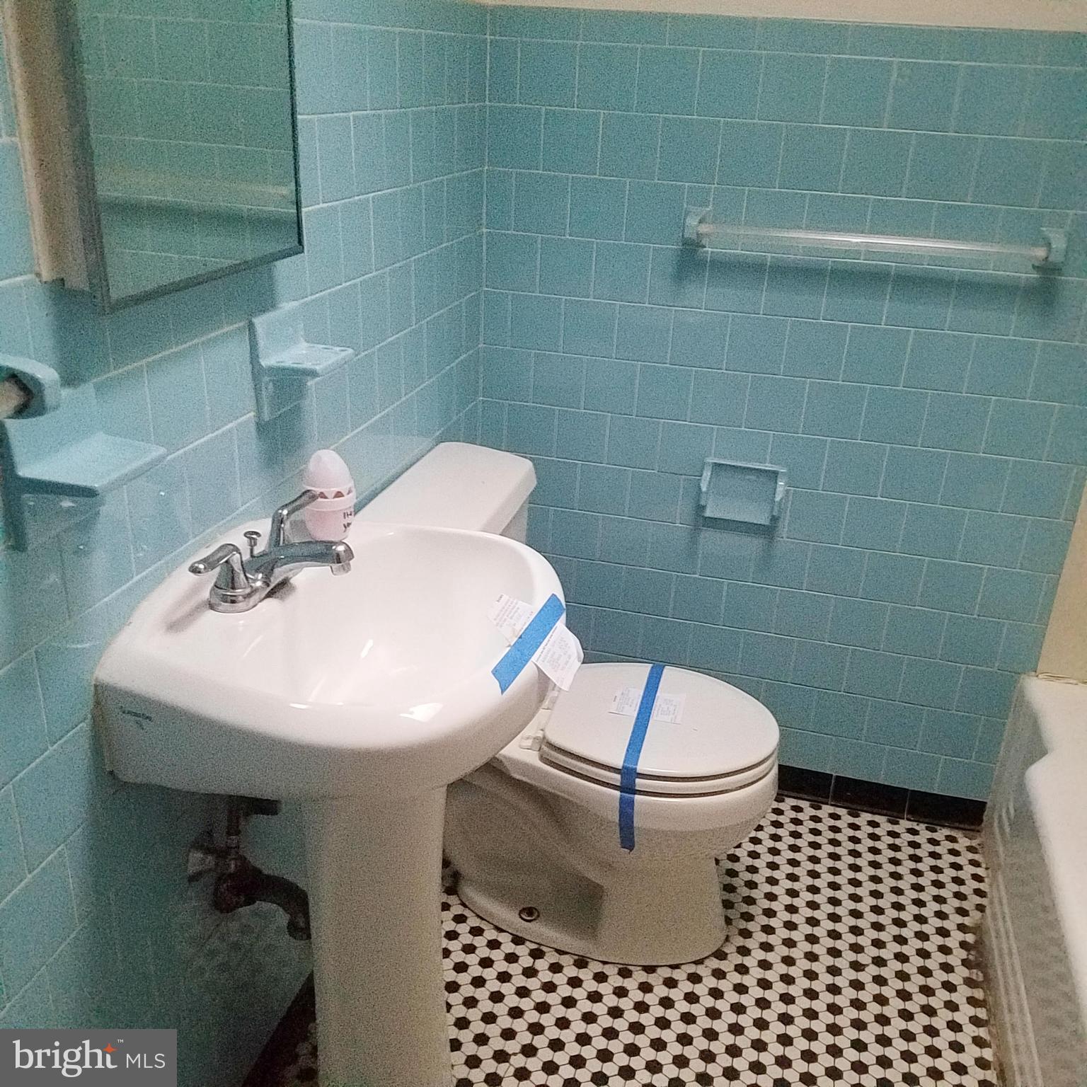 379 Marydell Road Baltimore, MD 21229 - Photo 11 of 14 a bathroom with a sink a toilet and a mirror