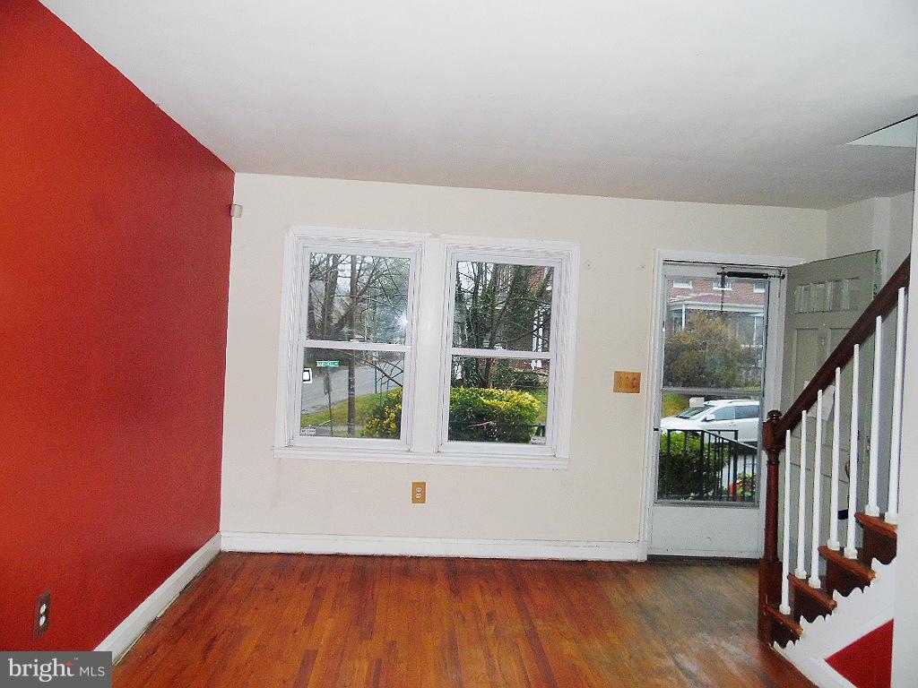 379 Marydell Road Baltimore, MD 21229 - Photo 4 of 14 a view of an empty room with wooden floor and a window