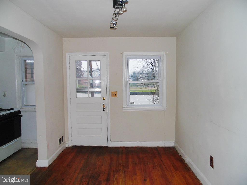 379 Marydell Road Baltimore, MD 21229 - Photo 6 of 14 an empty room with wooden floor and windows