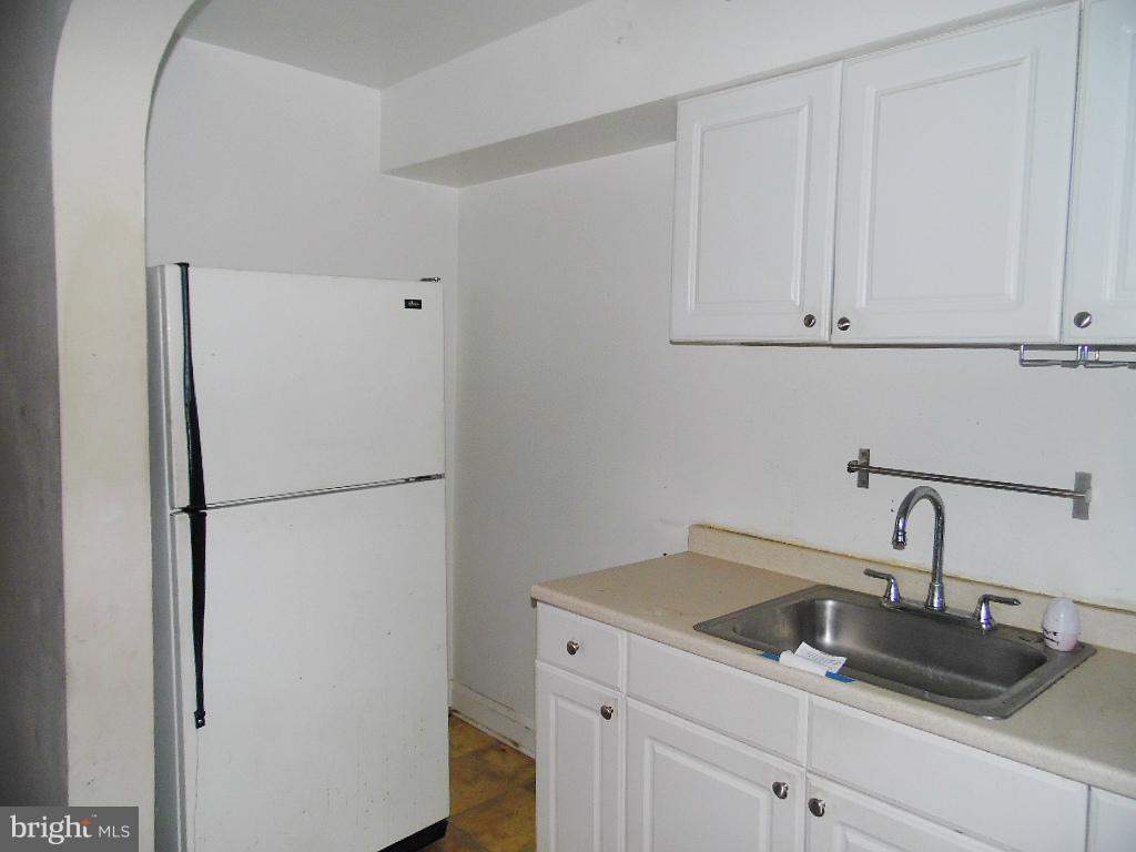 379 Marydell Road Baltimore, MD 21229 - Photo 7 of 14 a kitchen with a refrigerator and cabinets