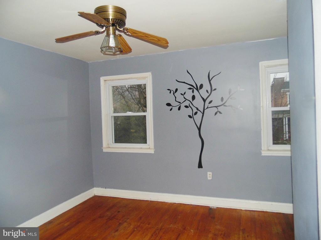 379 Marydell Road Baltimore, MD 21229 - Photo 9 of 14 a view of empty room with wooden floor and fan