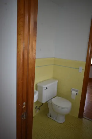 a bathroom with a sink a toilet and a mirror
