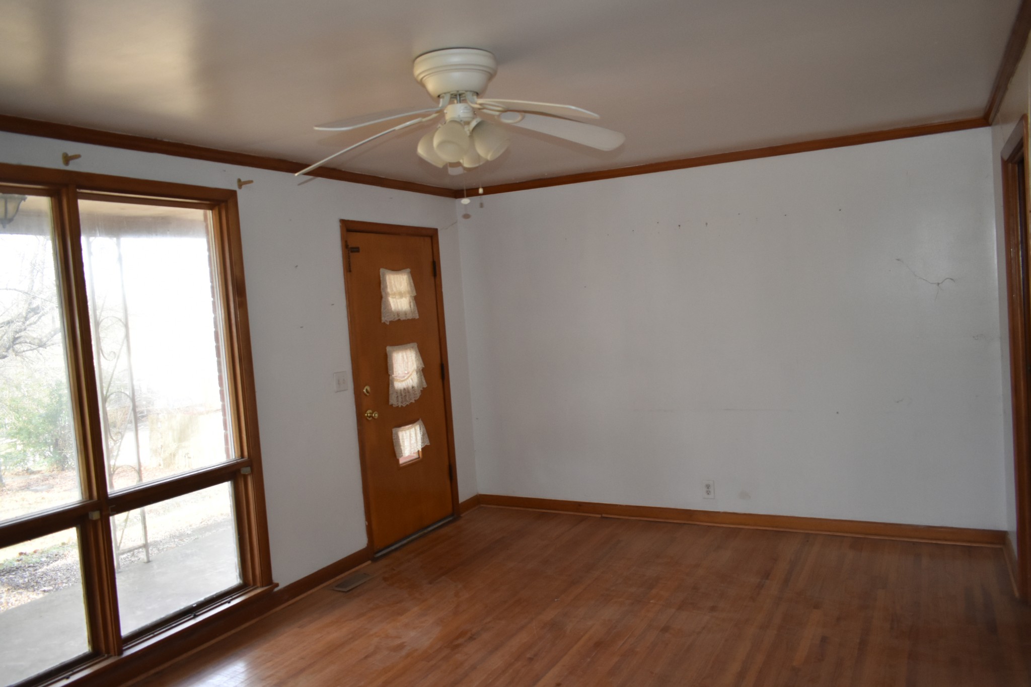 141 Hillcrest Drive Madison, TN 37115 - Photo 9 of 18 a view of an empty room with wooden floor and a window