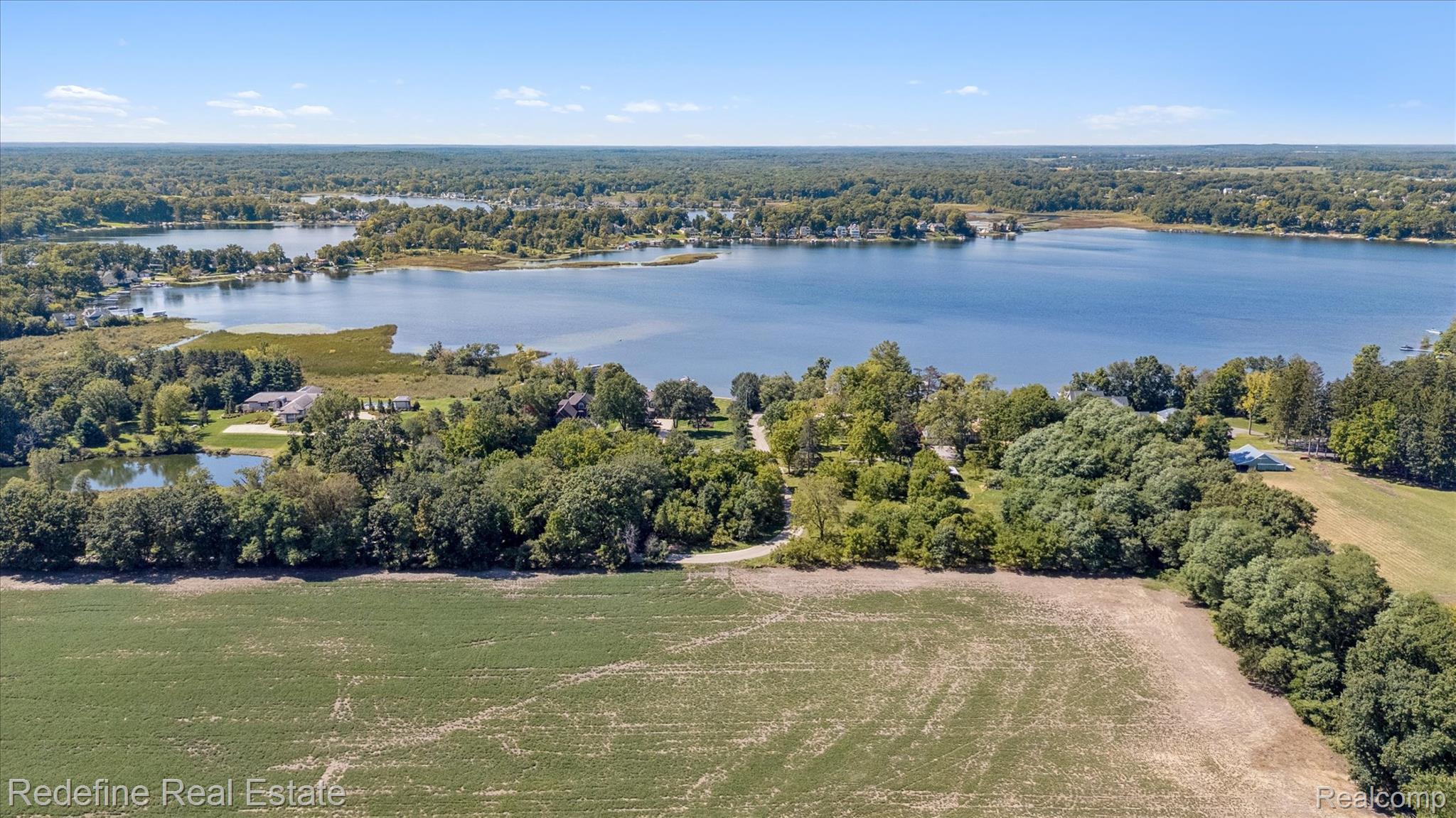 3777 Dorr Road Brighton, MI 48116 - Photo 63 of 77 Drone / aerial view of a large body of water and a forest
