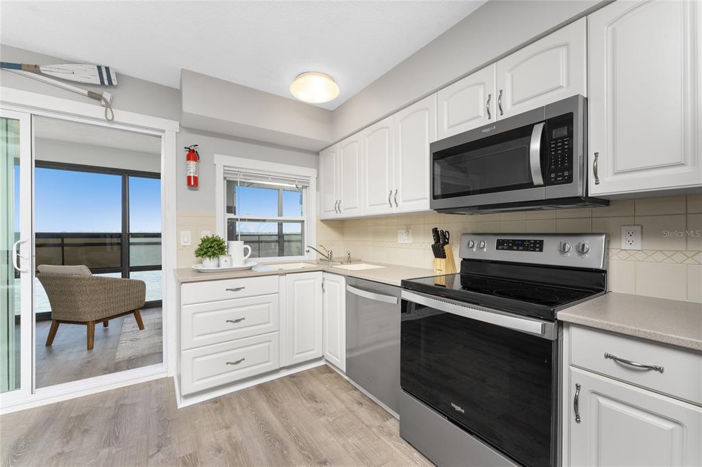 5041 North Beach Road, Unit 4A AND 4B Englewood, FL 34223 - Photo 12 of 75 a kitchen with cabinets appliances and a window