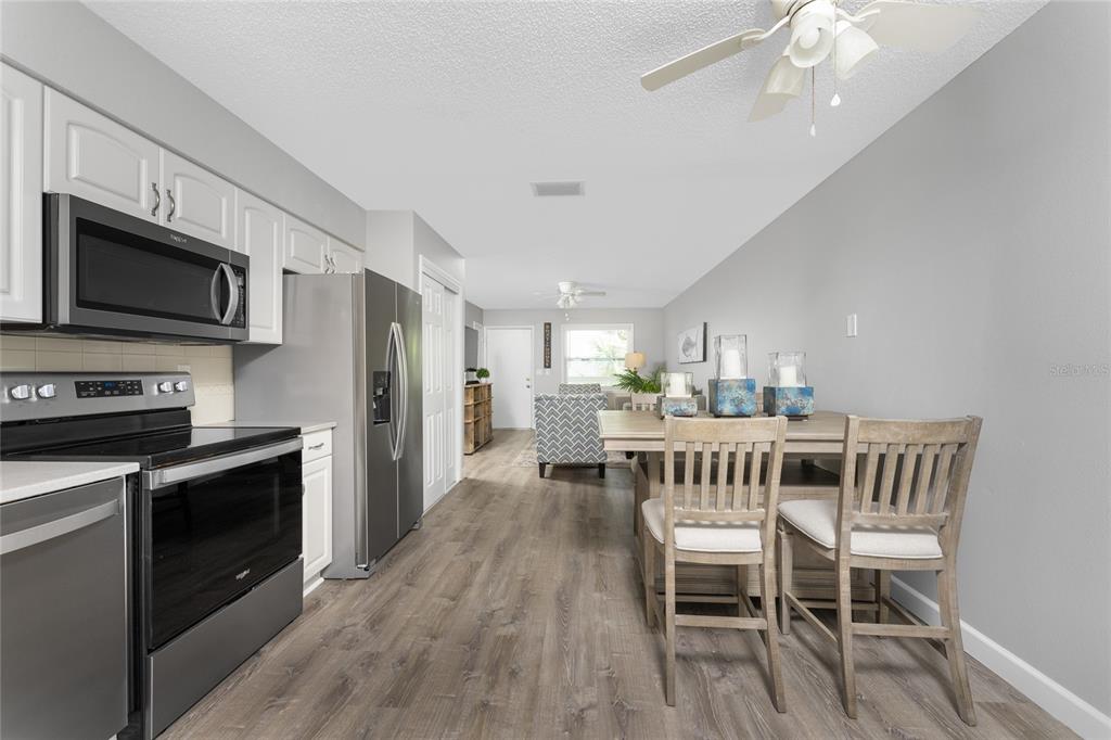 5041 North Beach Road, Unit 4A AND 4B Englewood, FL 34223 - Photo 17 of 75 a view of a dining room with furniture wooden floor and a kitchen