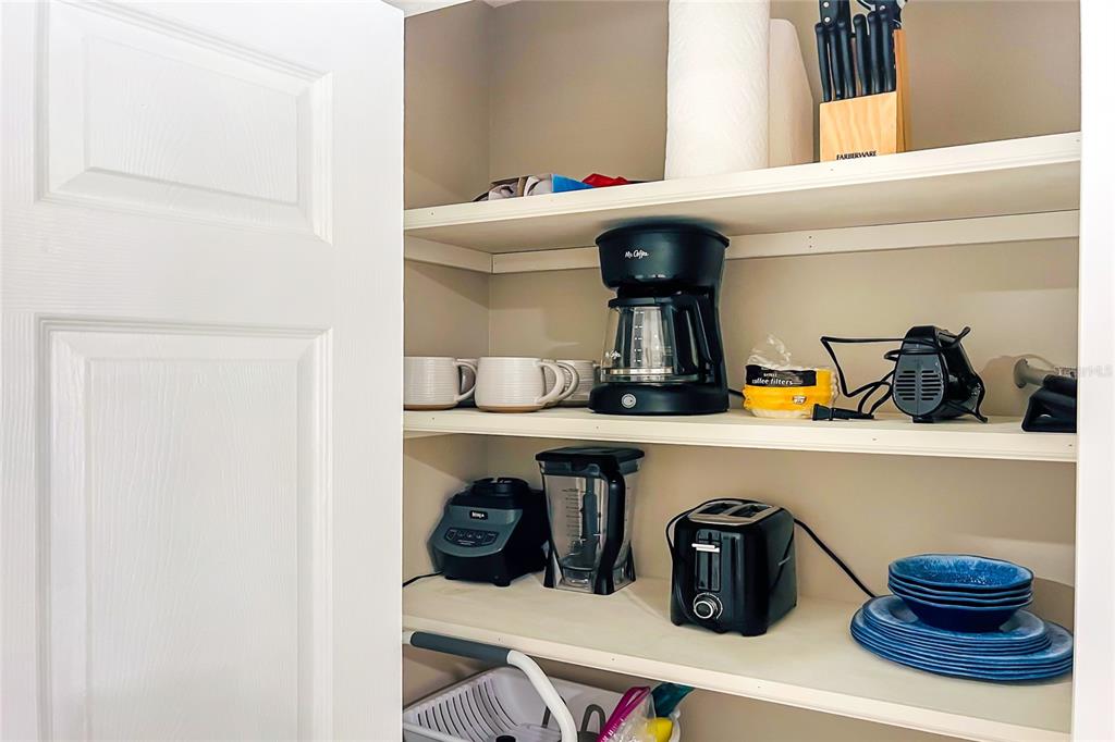 5041 North Beach Road, Unit 4A AND 4B Englewood, FL 34223 - Photo 35 of 75 a kitchen with a refrigerator and cabinets