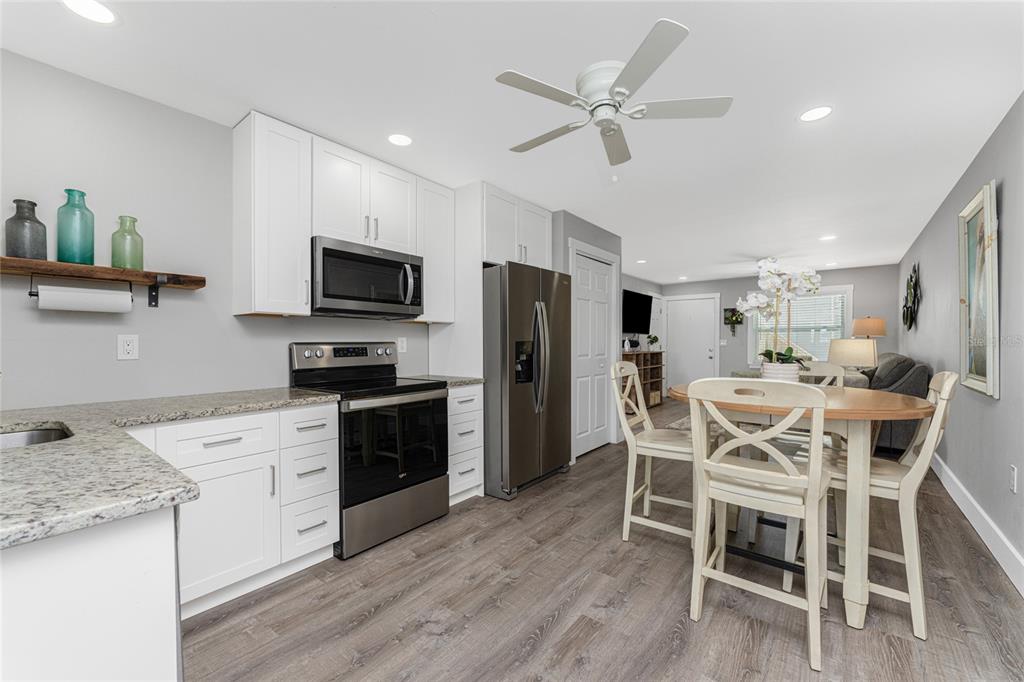 5041 North Beach Road, Unit 4A AND 4B Englewood, FL 34223 - Photo 59 of 75 a kitchen with a dining table chairs appliances and cabinets