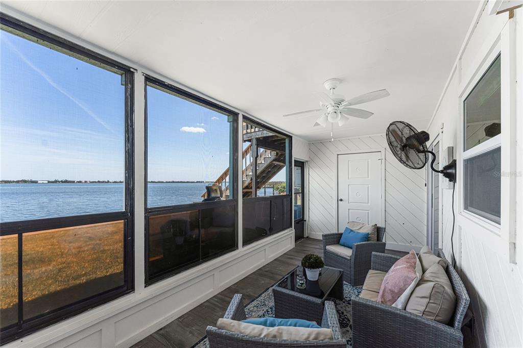 5041 North Beach Road, Unit 4A AND 4B Englewood, FL 34223 - Photo 62 of 75 a living room with furniture and a floor to ceiling window