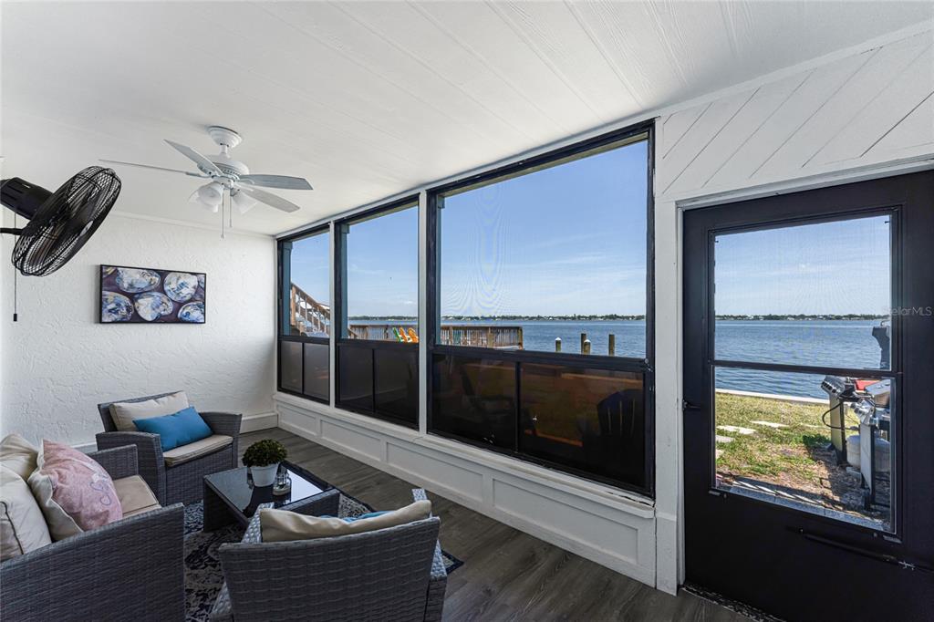 5041 North Beach Road, Unit 4A AND 4B Englewood, FL 34223 - Photo 64 of 75 a living room with furniture and a floor to ceiling window