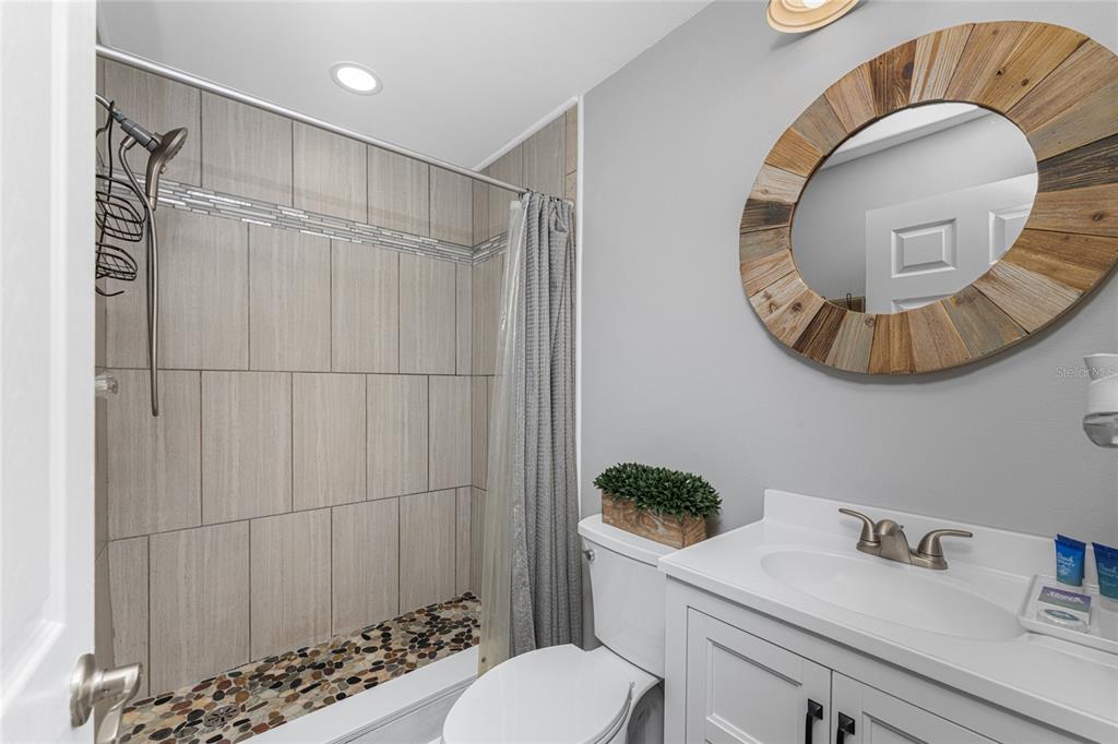 5041 North Beach Road, Unit 4A AND 4B Englewood, FL 34223 - Photo 69 of 75 a bathroom with a sink mirror toilet and vanity