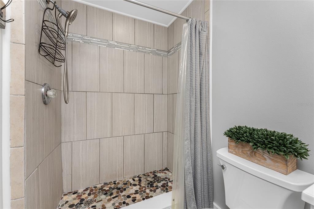 5041 North Beach Road, Unit 4A AND 4B Englewood, FL 34223 - Photo 70 of 75 a bathroom with a toilet and a shower