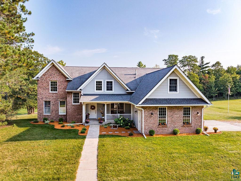 3168 Pioneer Road Barnum, MN 55707 - Photo 6 of 46 Traditional-style home with a front yard, brick and metal siding, covered porch, and a shingled roof with beautiful Anderson windows!
