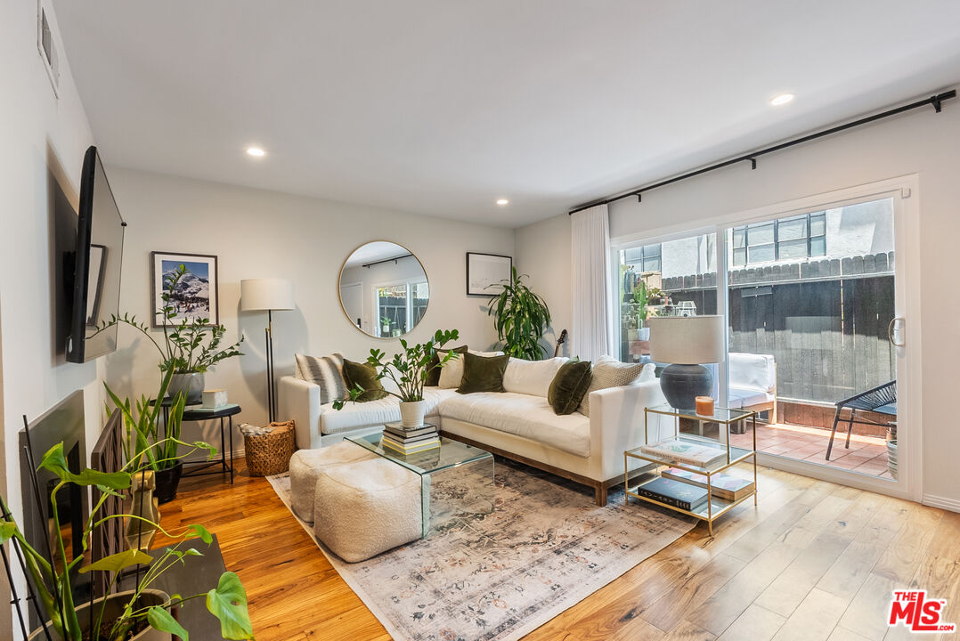 a living room with furniture and a floor to ceiling window