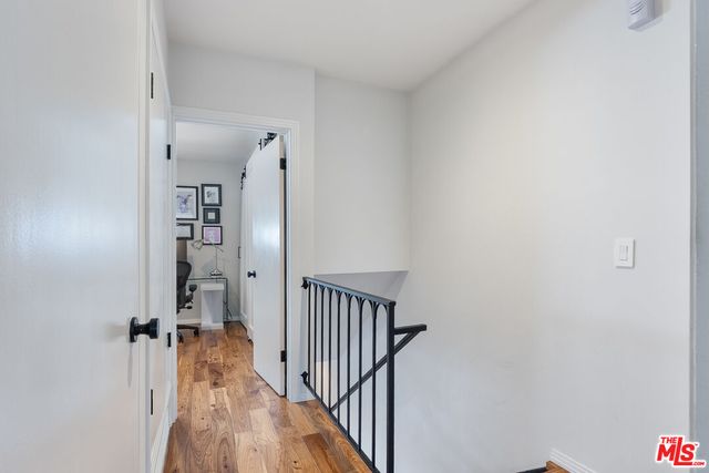 a view of a hallway with a white walls and stairs