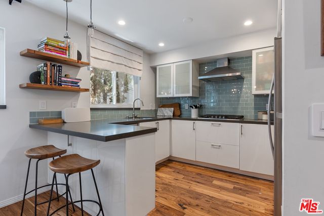 a kitchen with stainless steel appliances granite countertop a sink and cabinets