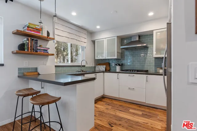 a kitchen with stainless steel appliances granite countertop a sink and cabinets