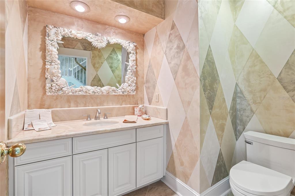 17810 Crawley Road Odessa, FL 33556 - Photo 32 of 76 a bathroom with a granite countertop sink mirror vanity and toilet