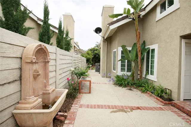a front view of a house with outdoor seating and plants