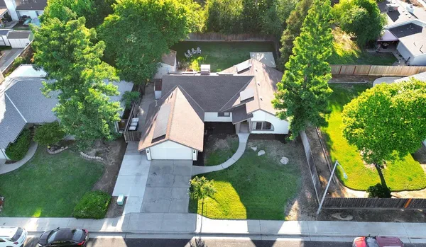 an aerial view of a house with yard swimming pool and outdoor seating
