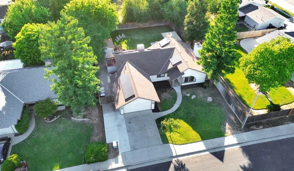 an aerial view of a house with yard swimming pool and outdoor seating