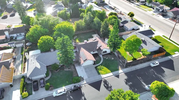 an aerial view of a house with swimming pool garden and patio