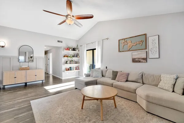 a living room with furniture and wooden floor