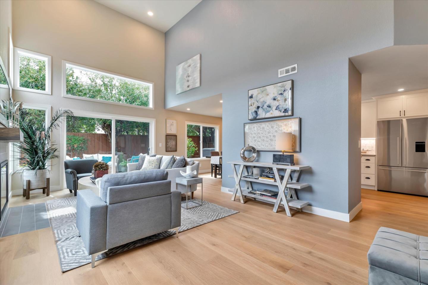 a living room with furniture water view and large windows