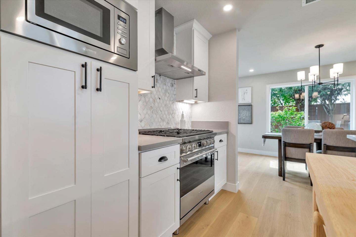 682 Ridgeview Terrace Fremont, CA 94536 - Photo 12 of 38 a kitchen with stainless steel appliances granite countertop a stove a sink and a refrigerator
