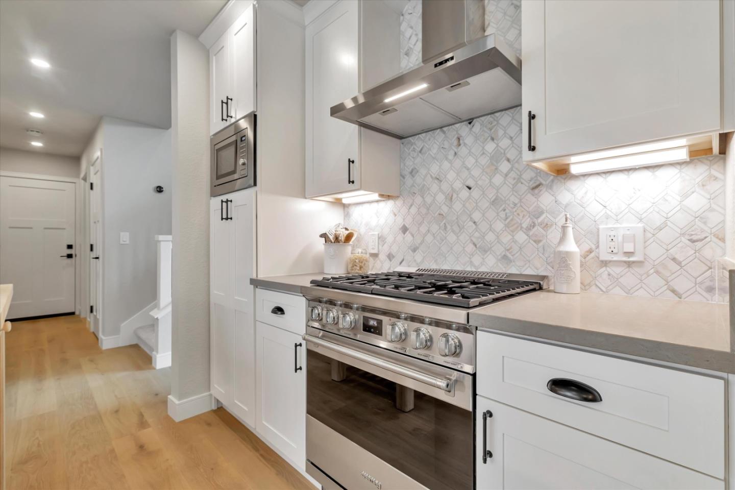 682 Ridgeview Terrace Fremont, CA 94536 - Photo 13 of 38 a kitchen with a stove and a wooden floor