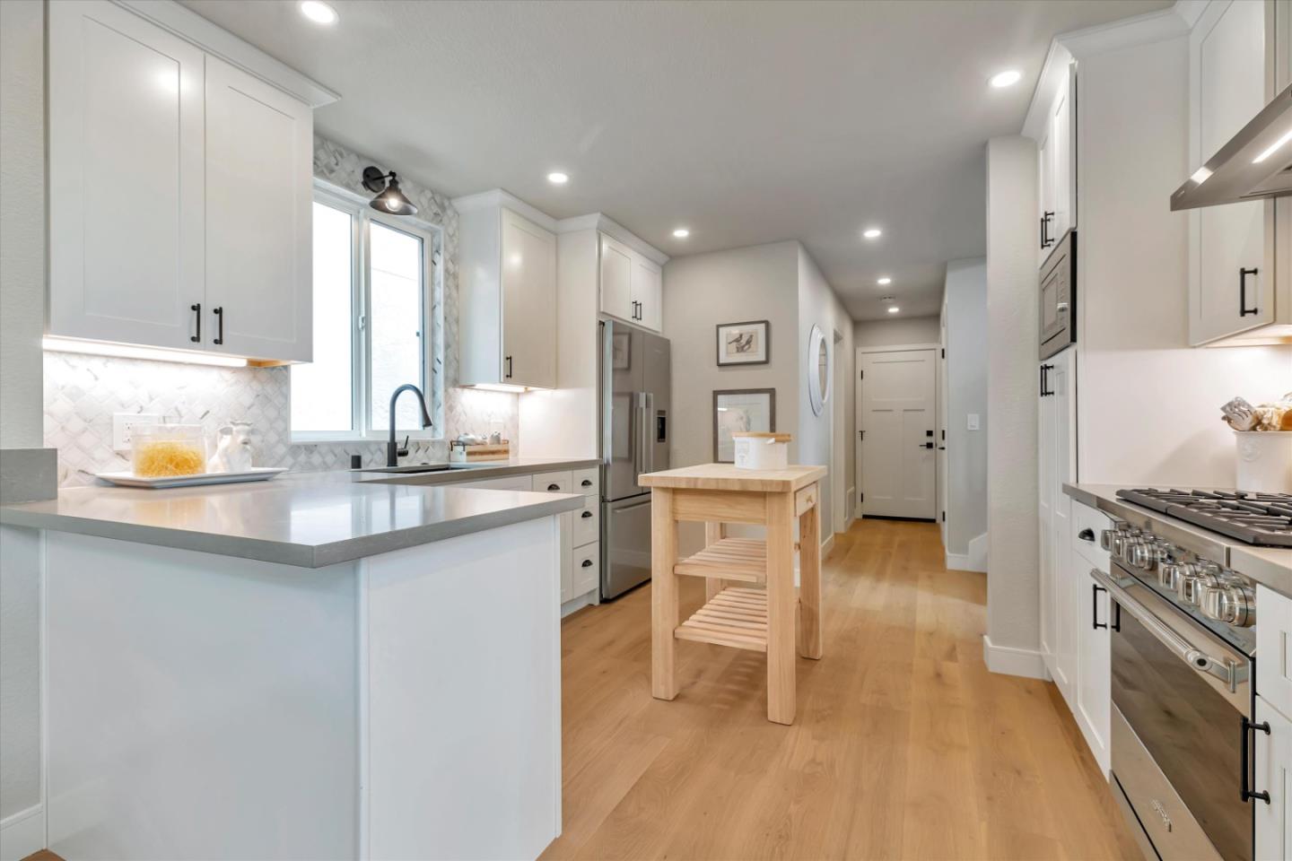 682 Ridgeview Terrace Fremont, CA 94536 - Photo 14 of 38 a kitchen with a sink cabinets and wooden floor