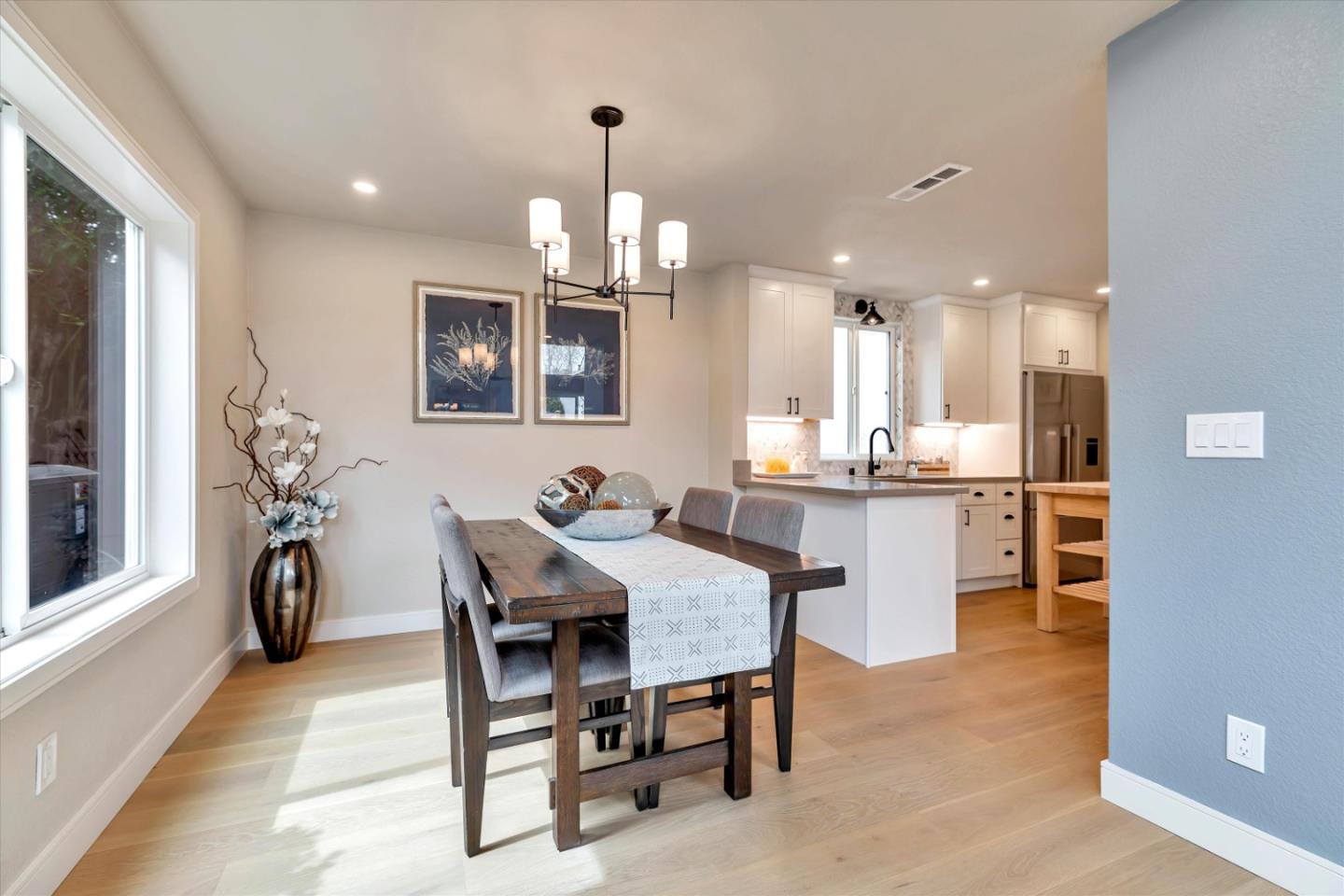 682 Ridgeview Terrace Fremont, CA 94536 - Photo 16 of 38 a view of a dining room and livingroom with furniture a rug a potted plant and a chandelier