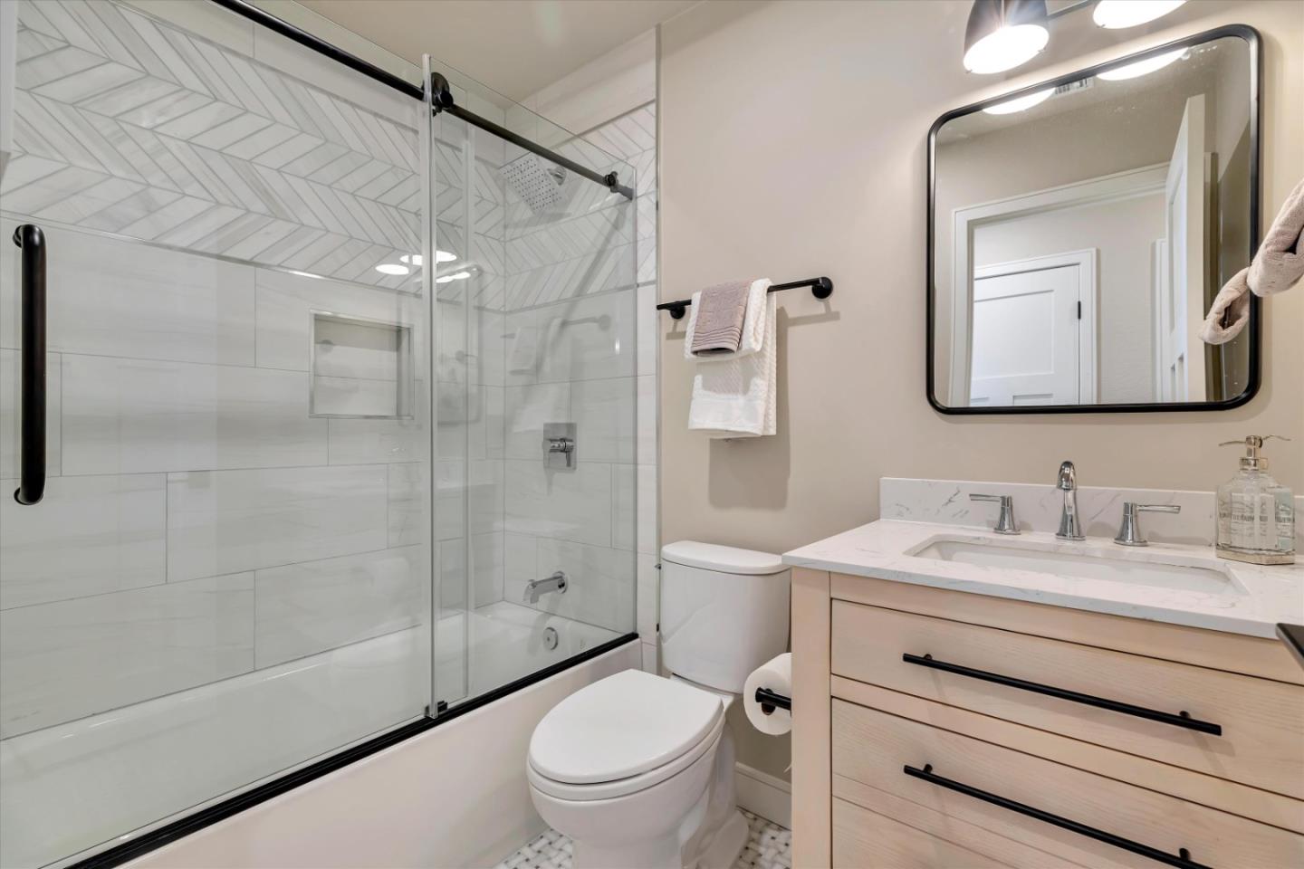 682 Ridgeview Terrace Fremont, CA 94536 - Photo 19 of 38 a bathroom with a toilet a sink a glass door a shower a mirror and vanity