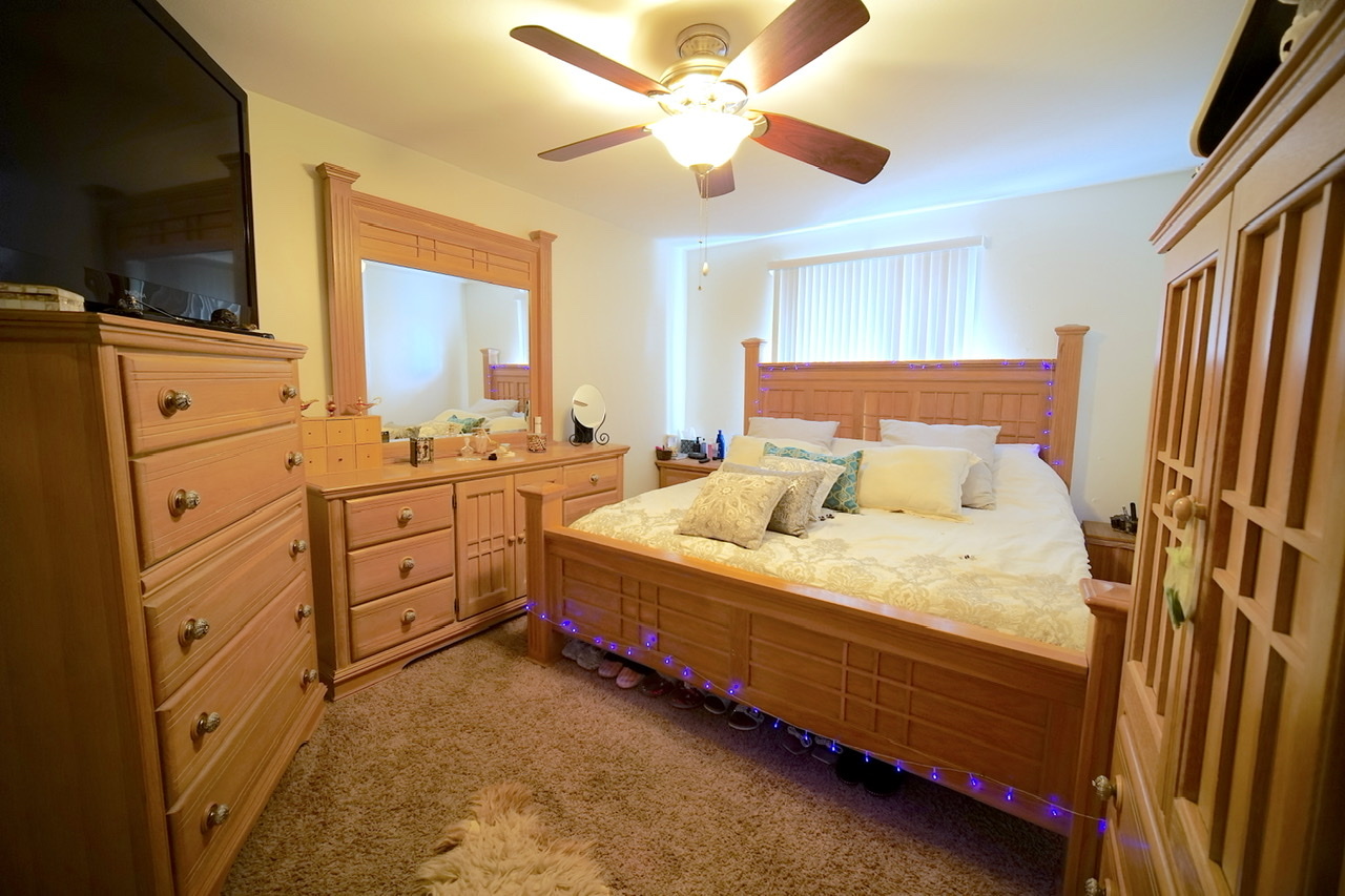9835 South Harlem Avenue, Unit S Chicago Ridge, IL 60415 - Photo 11 of 17 a bedroom with a bed and a flat screen tv