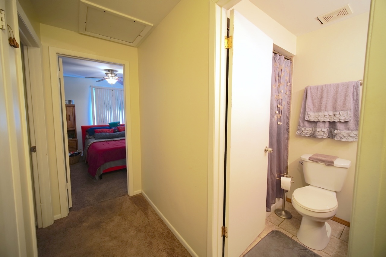 9835 South Harlem Avenue, Unit S Chicago Ridge, IL 60415 - Photo 14 of 17 a bathroom with a toilet a sink and a mirror