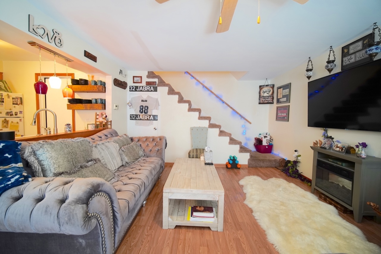 9835 South Harlem Avenue, Unit S Chicago Ridge, IL 60415 - Photo 7 of 17 a living room with furniture and a flat screen tv